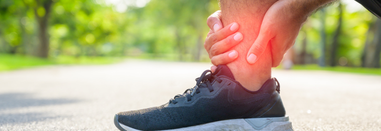 person scratching his itchy ankle