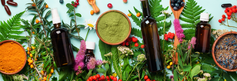 green plants, skin care bottles and natural home remedies