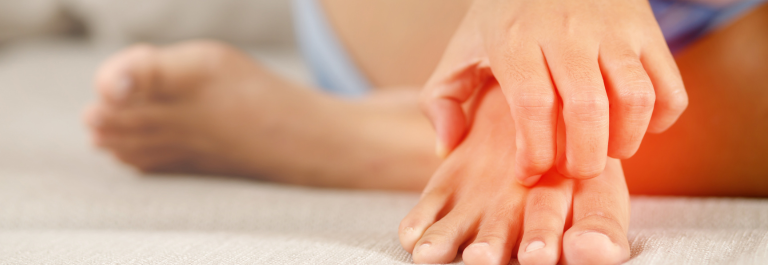 person scratching itchy foot