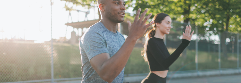 man and woman exercising outside 